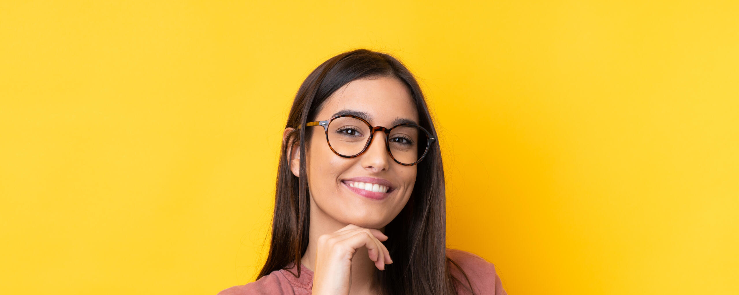 Stylish Frames in Om Optics A smiling person trying new frame.
