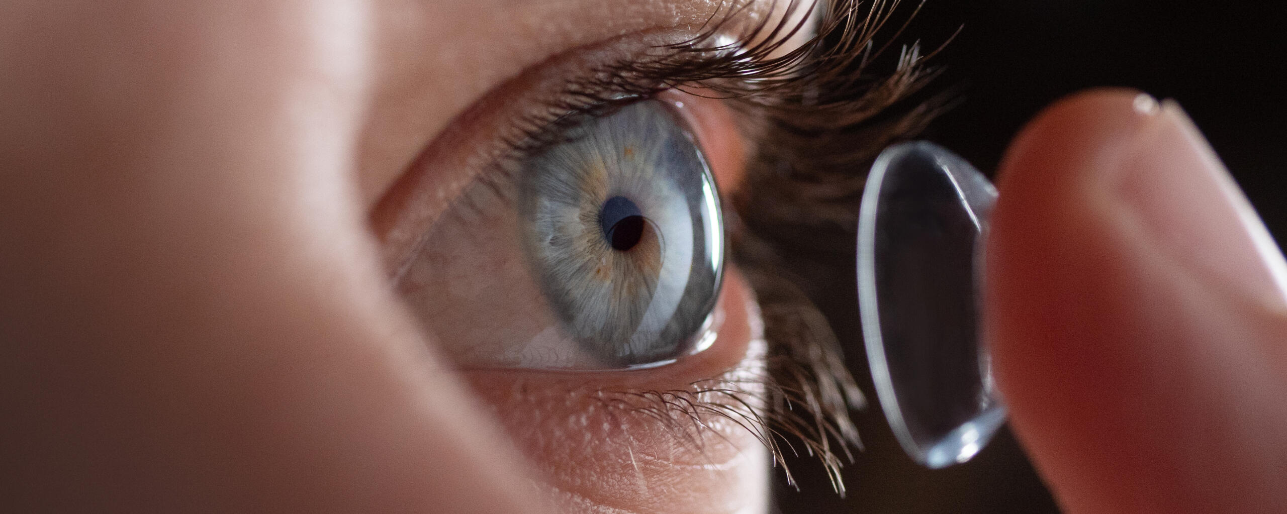 Contact Lenses and solutions at Om Optics Close-up of a person applying a soft contact lens to the eye for vision correction at Om Optics in Tokha, Kathmandu