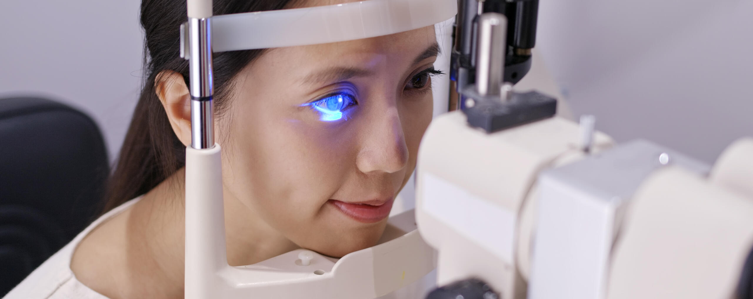 Eye Exam at Om Optics Young woman undergoing a professional eye checkup with a slit lamp at Om Optics in Tokha, Kathmandu